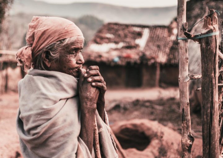 A poor elderly woman praying