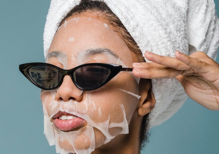 A woman with a face mask, hair treatment and sunglasses, trying to lift her self esteem