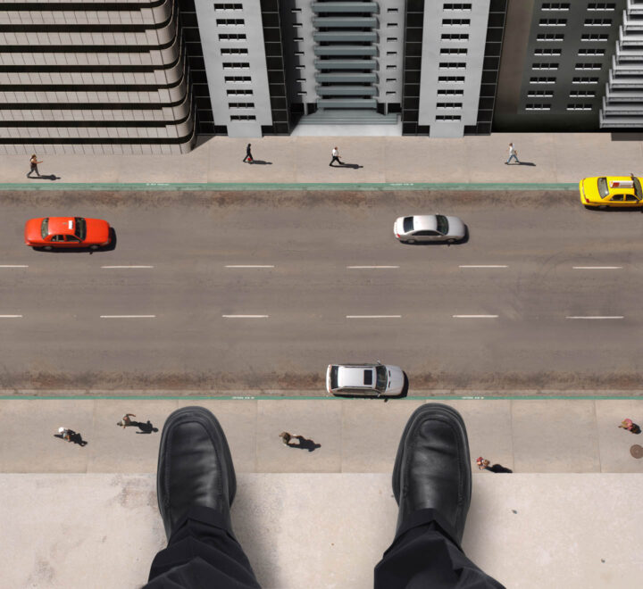 A man contemplating to jump from the top of an apartment building