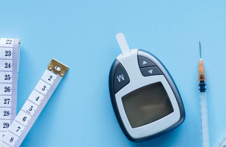 A blood glucose monitor and a measuring tape