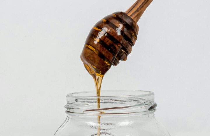 Taking honey out of a jar
