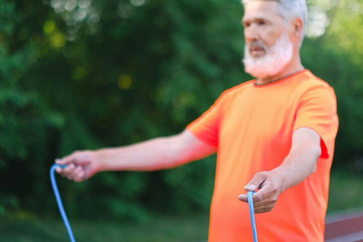 An elderly man preparing for rope jumping