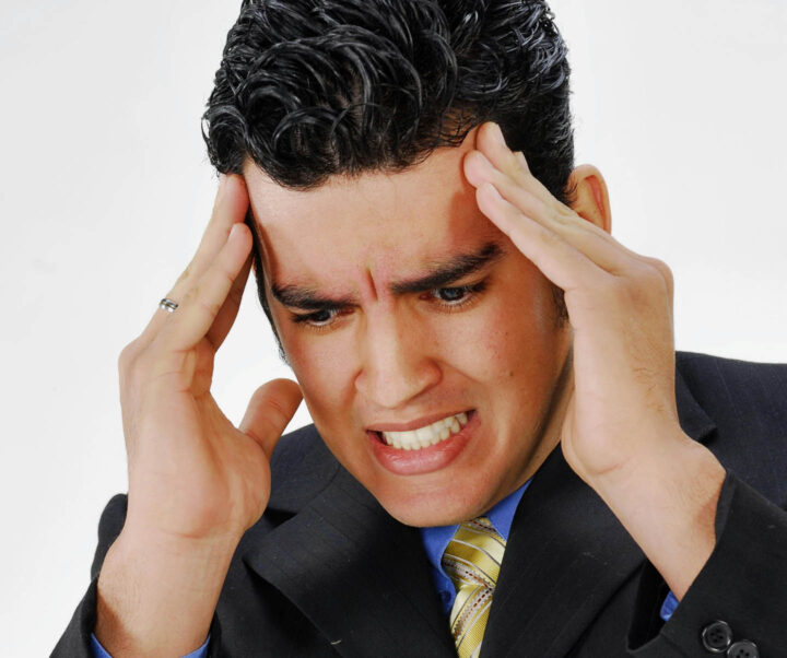 A businessman battling with migraine headache