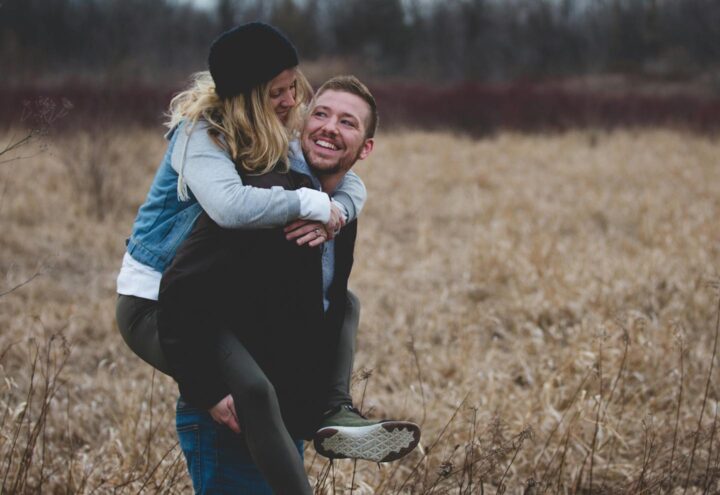 A man carrying his wife and enjoying nature together
