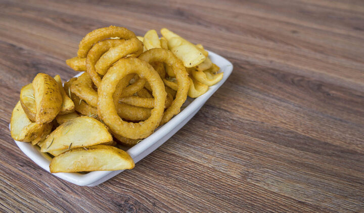 A dish of potatoes and fried onion rings