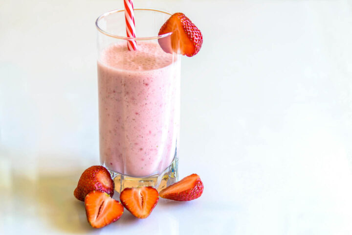 A shake topped with one strawberry