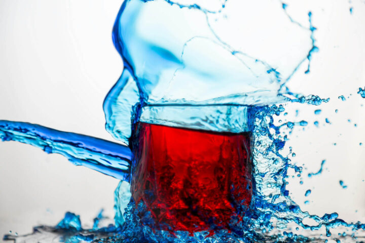 A glass of soft drink with a water splash