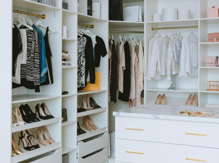 A wardrobe of a woman filled with shoes and clothes