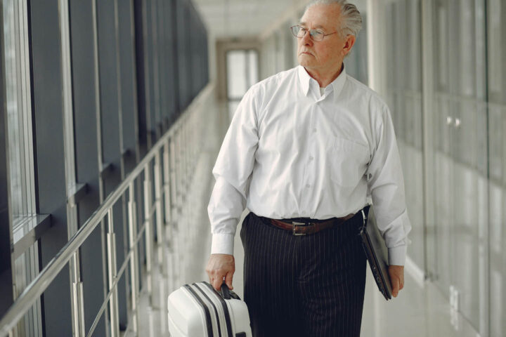 A businessman disembarking a plane on an airport