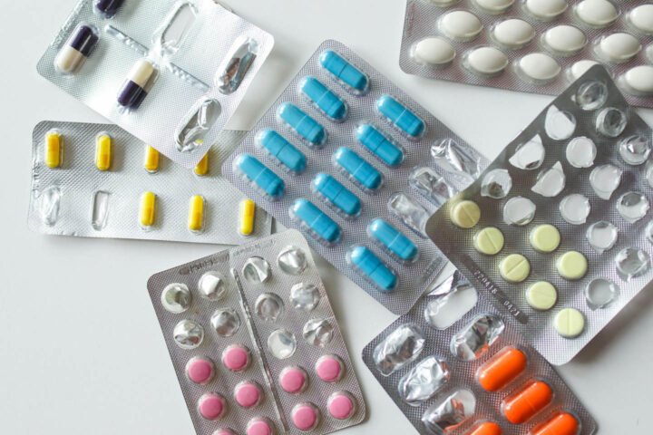 Several packs of medication spread out on a table
