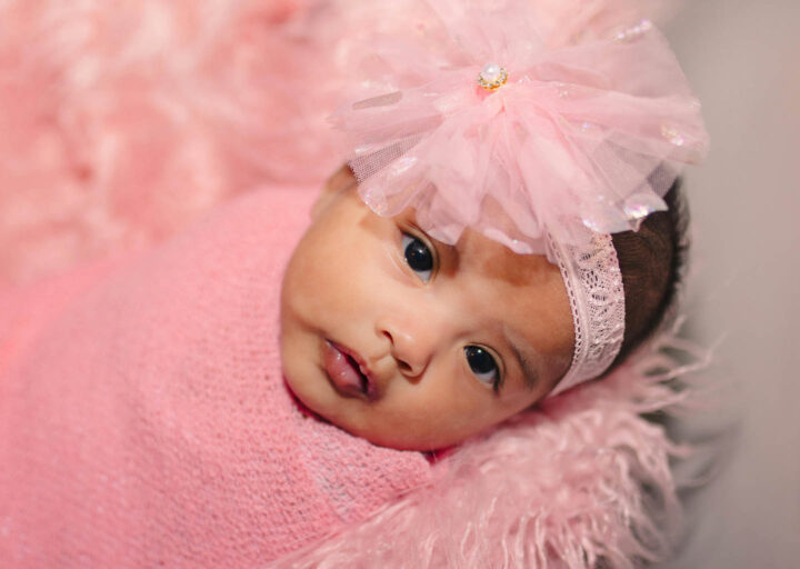 A baby girl looking attentive to recognize faces