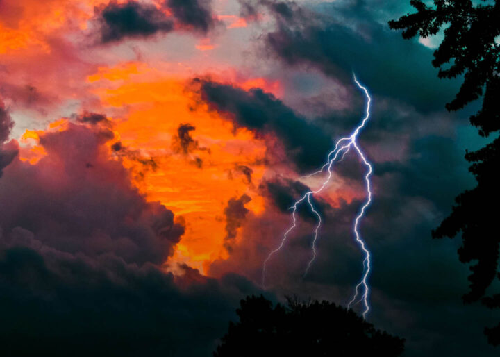 A storm forming with lightning piercing the sky